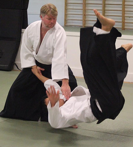 Photo of Sensei Jonathan Reid throwing another black belt at the dojo