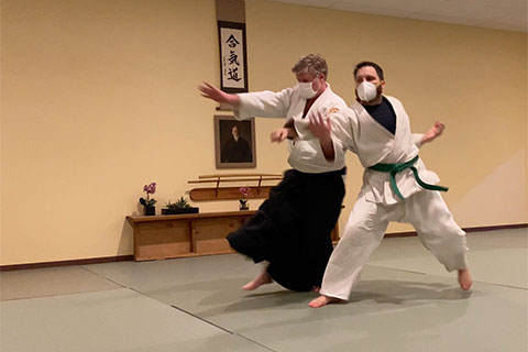 Sensei demonstrating a technique against a punch