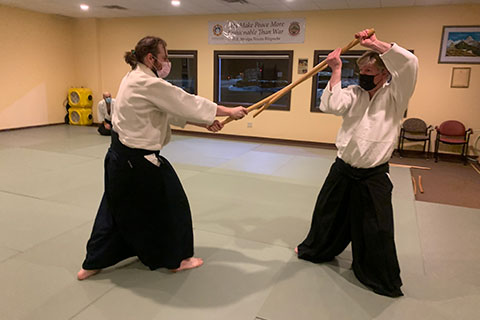Black belts practicing with bokken